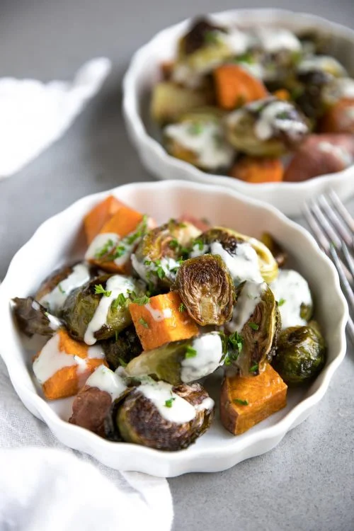 tahini brussel sprouts in white bowl