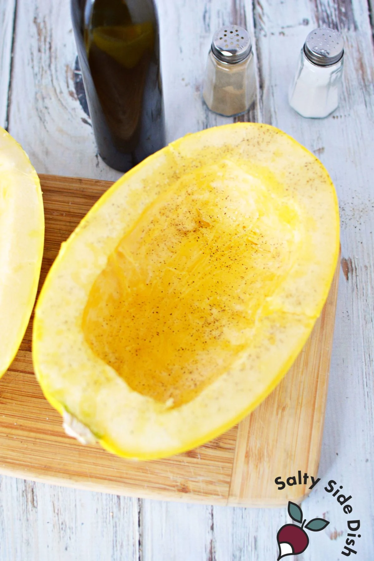 adding seasoning to squash halves.