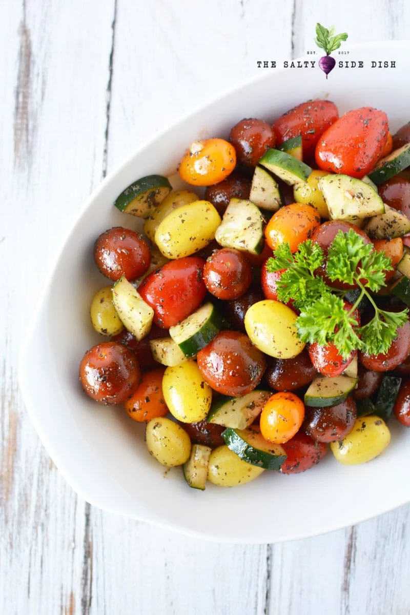 tomato side dish recipe in a bowl with fresh parsley
