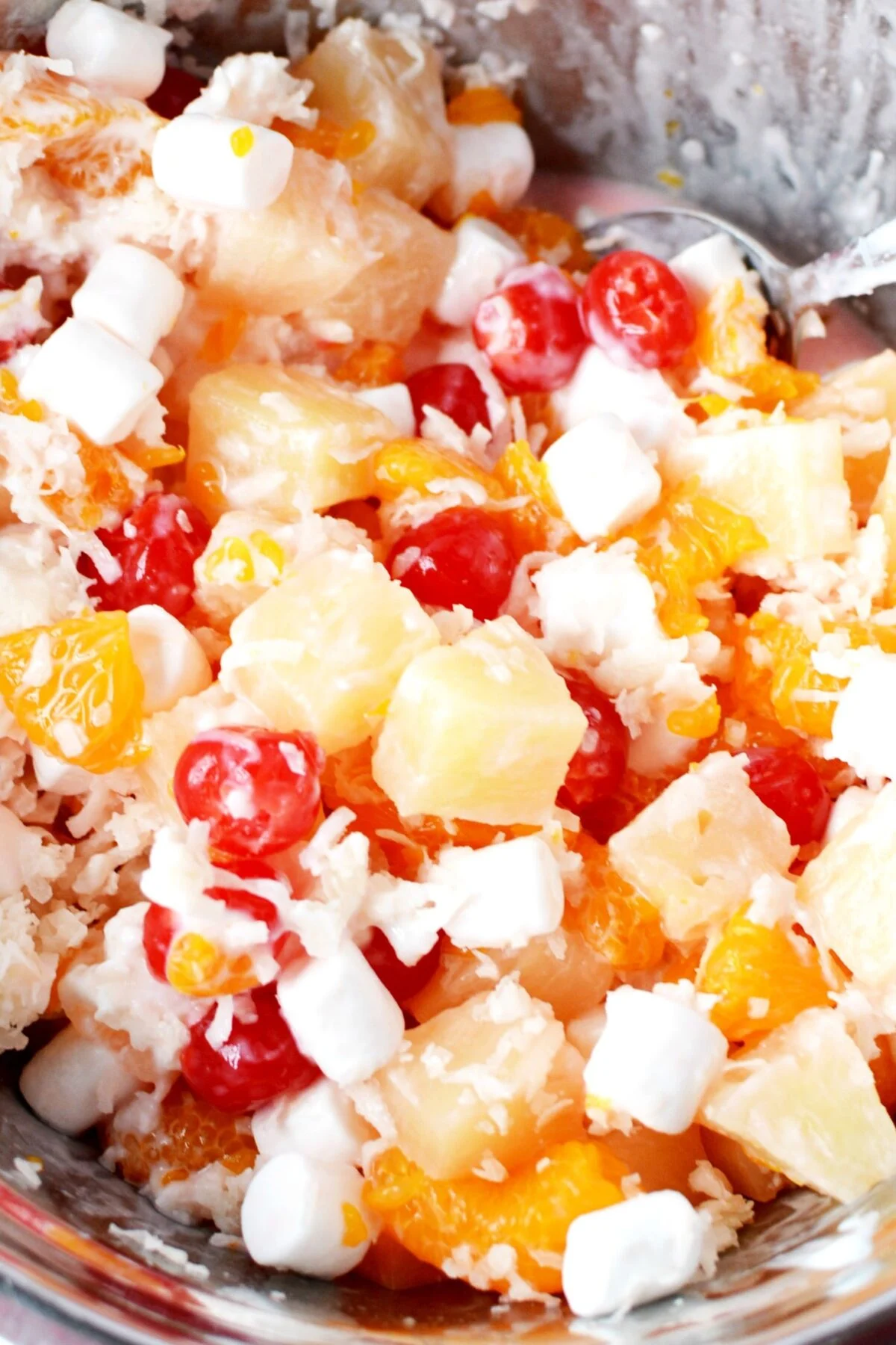 ambrosia salad in a bowl with lots of cherries.