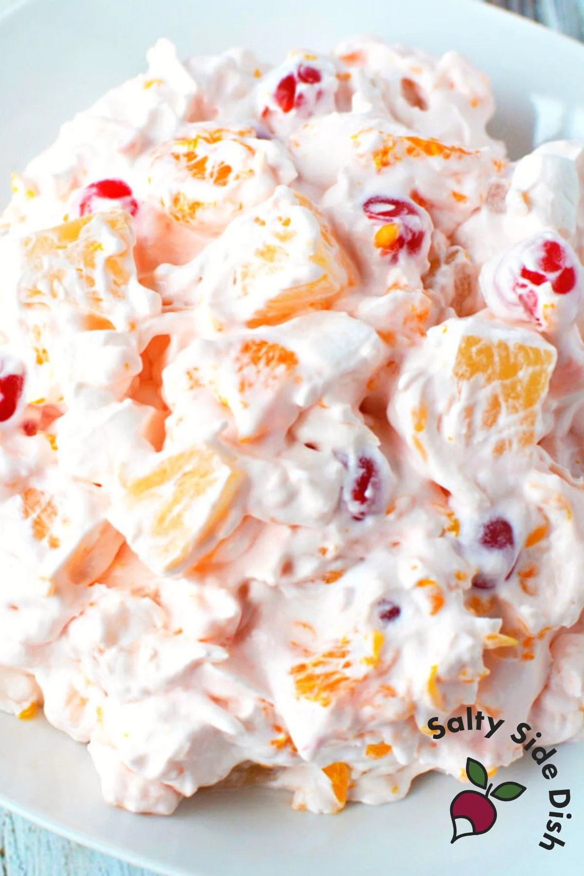 cherry oranges and cool whip make up the best fluff ambrosia salad recipe.