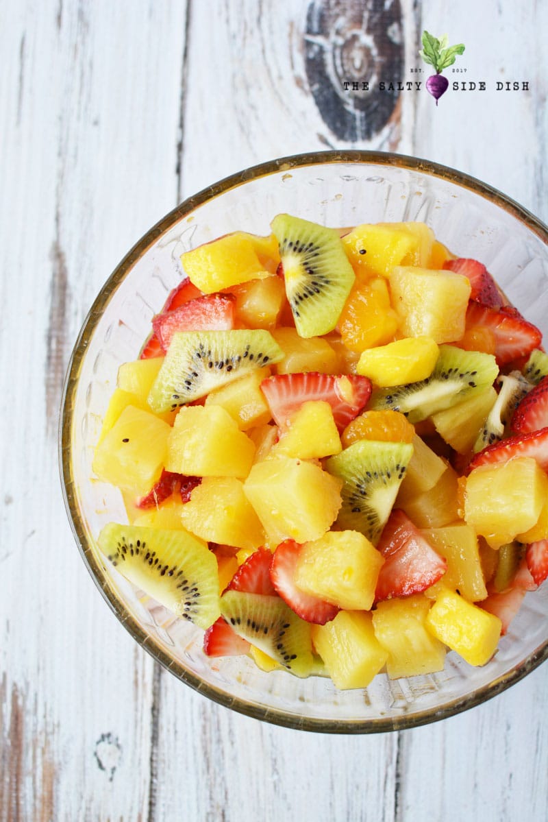Fall fruit salad with honey and lemon, kiwis and pineapple in a bowl