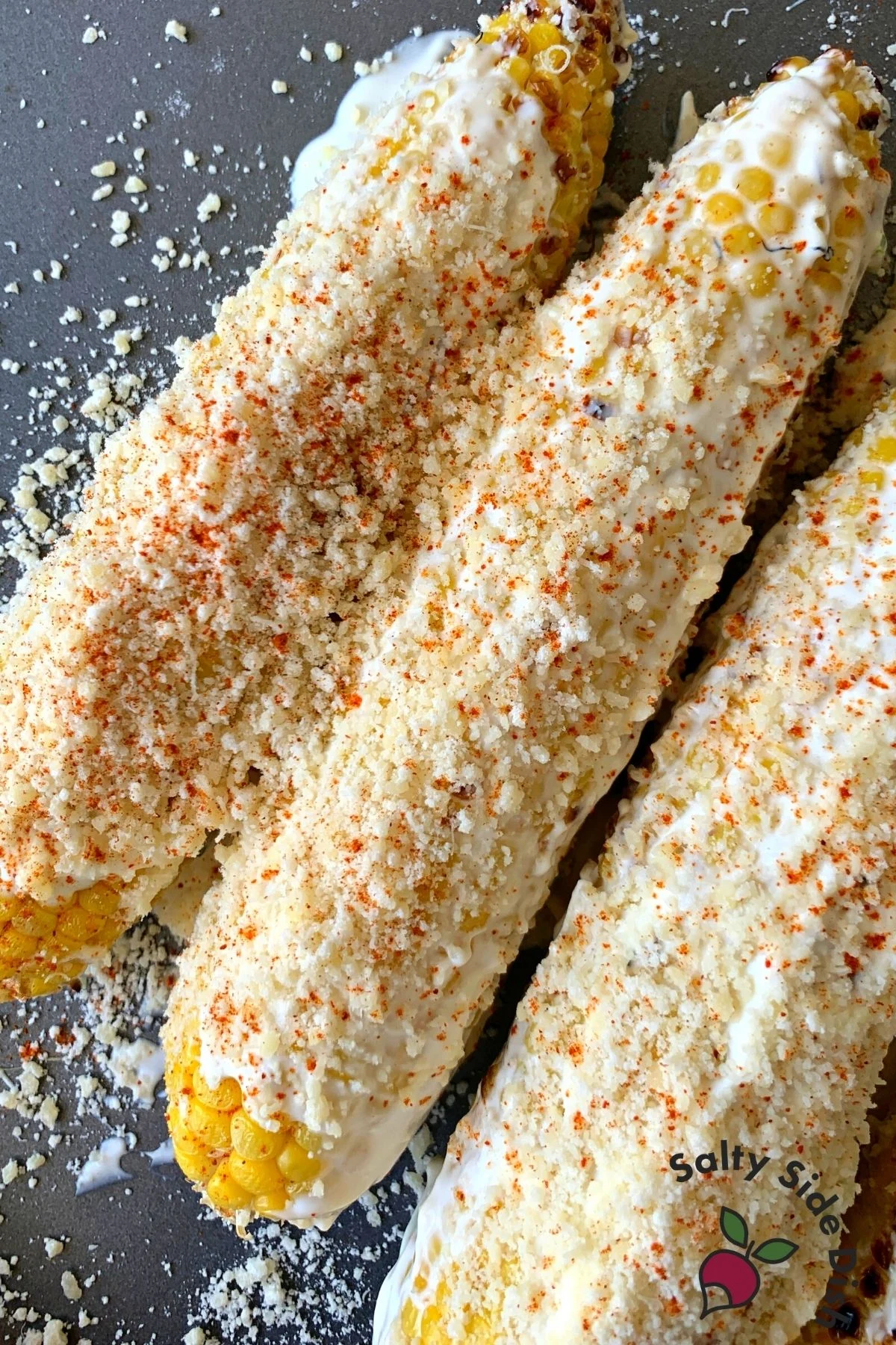 Corn on the cob with mayo and parmesan.