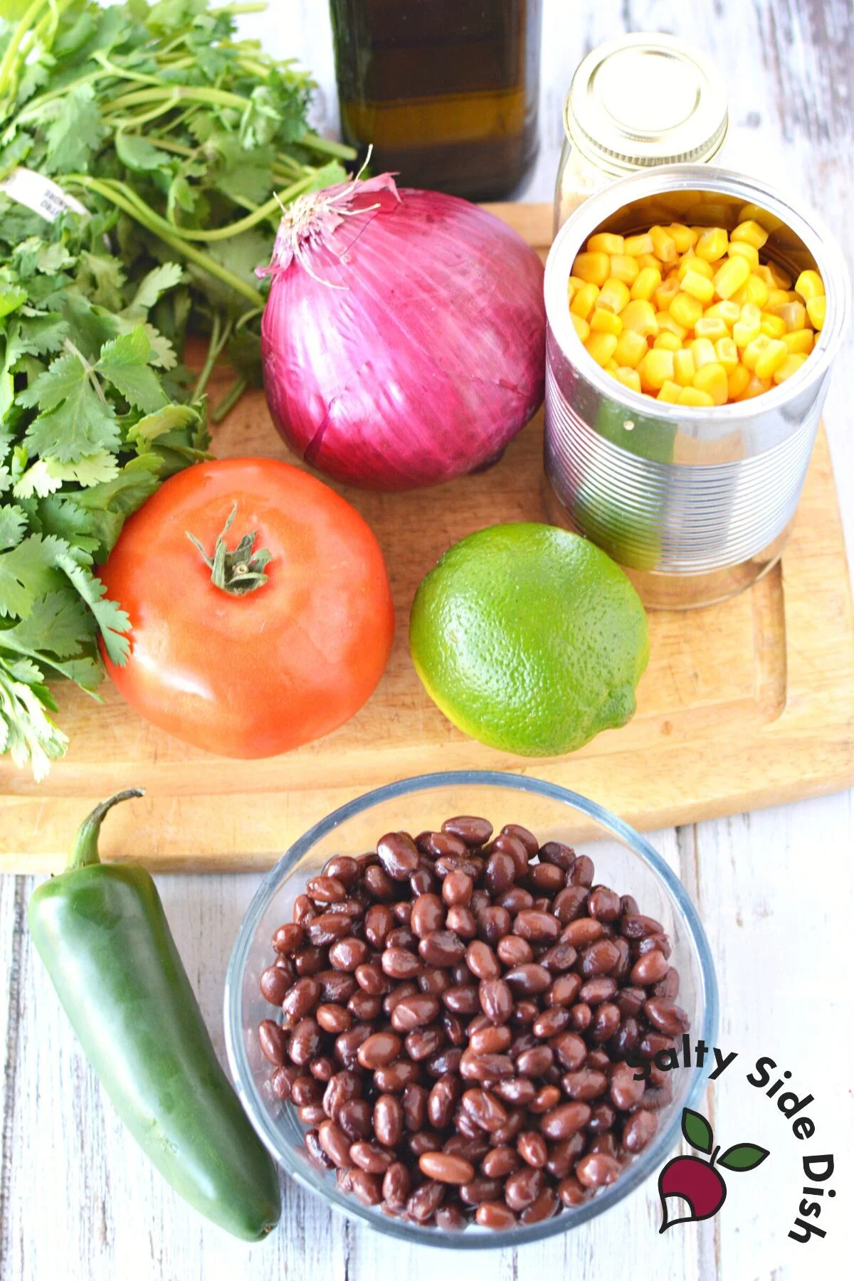 all salsa dip ingredients laid out on cutting board ready for prep.