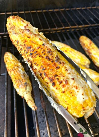 holding a piece of street corn.