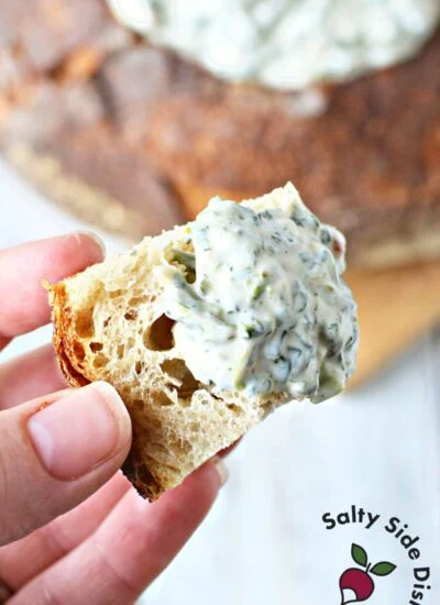 cold spinach dip being dipped with bread pieces.