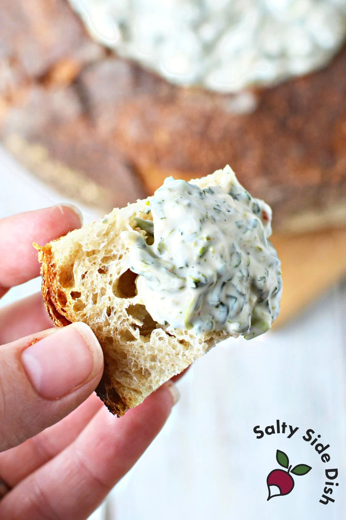 cold knorr spinach dip recipe being dipped with bread pieces.
