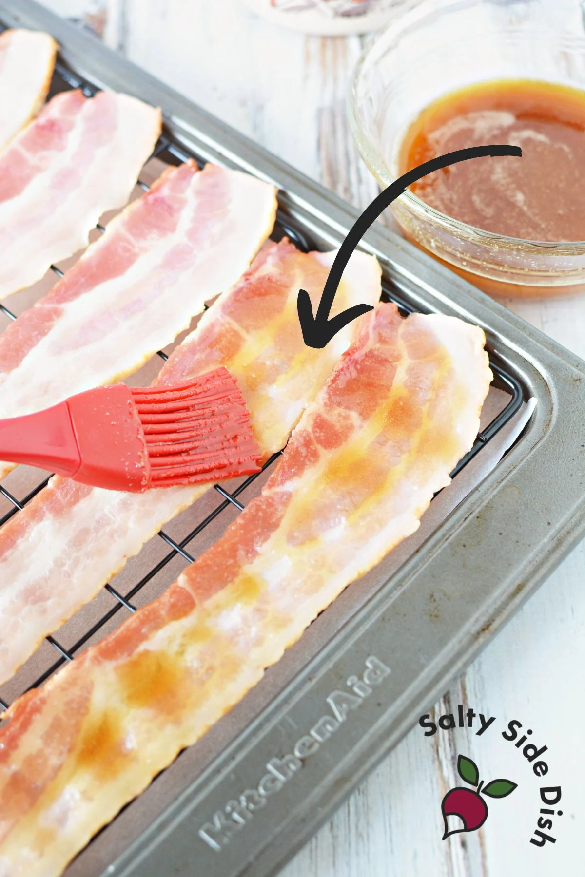 using a baster to add glaze to bacon.