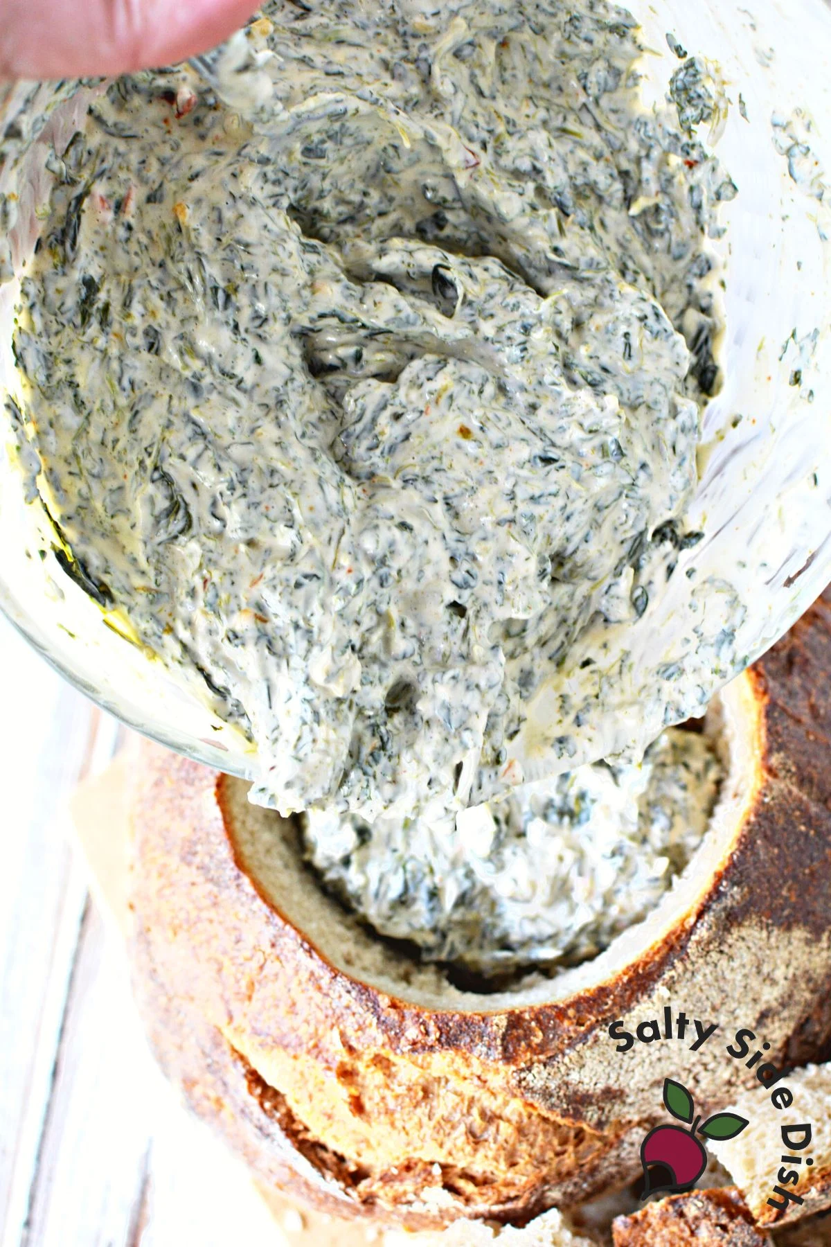 classic bread bowl in spinach dip.