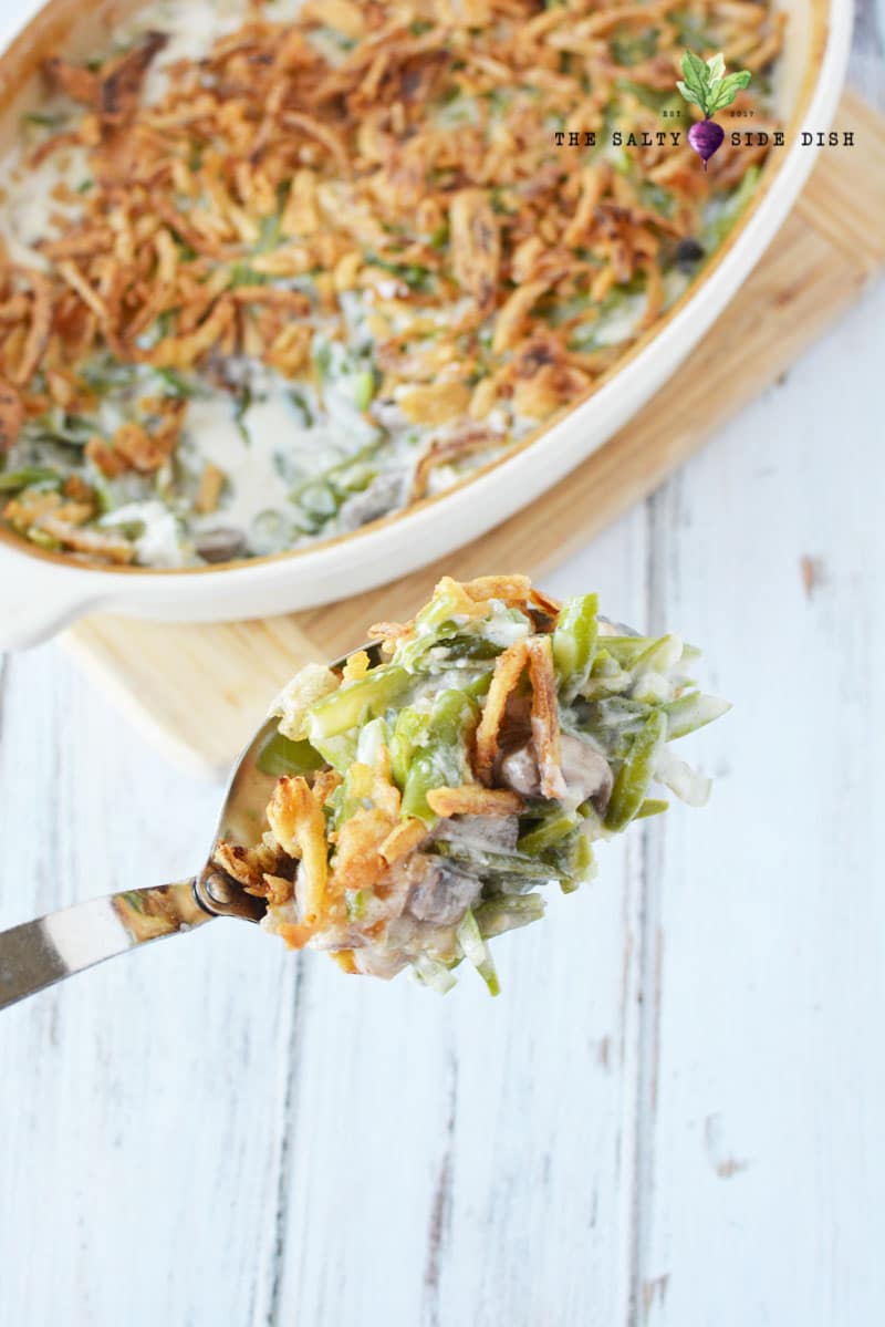 green bean side dish with serving spoon and casserole being served