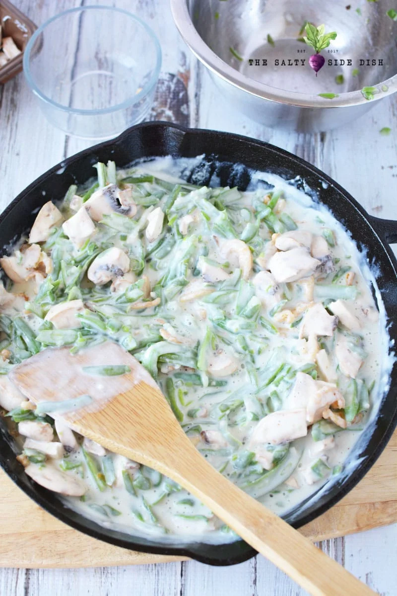 green bean casserole in a cast iron pan on the stove top