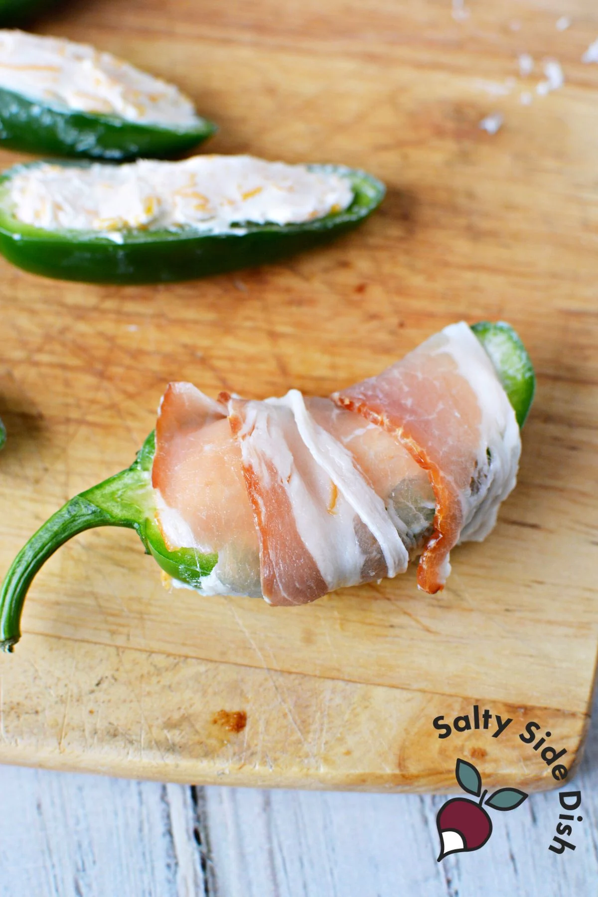 wrap a jalapeno with half slice of bacon.