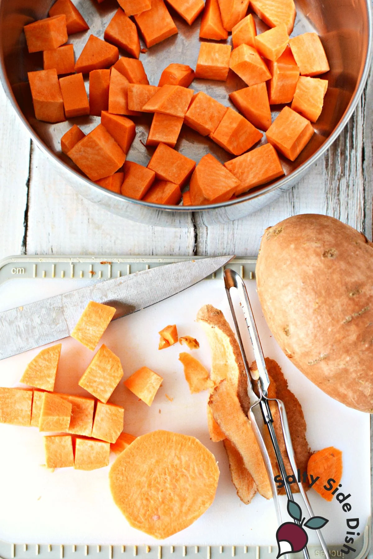 peeling and cubed sweet potatoes in a stovetop pot.