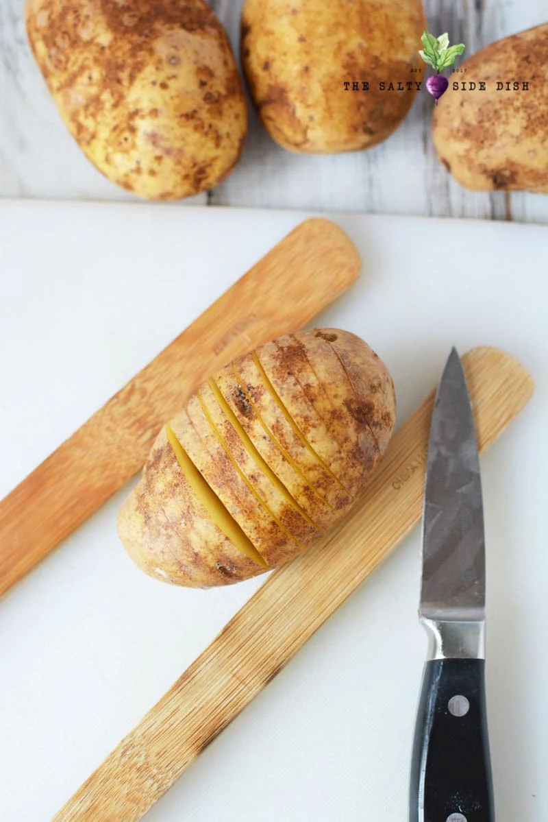 hasselback potato cut into slices and prepped for stuffing