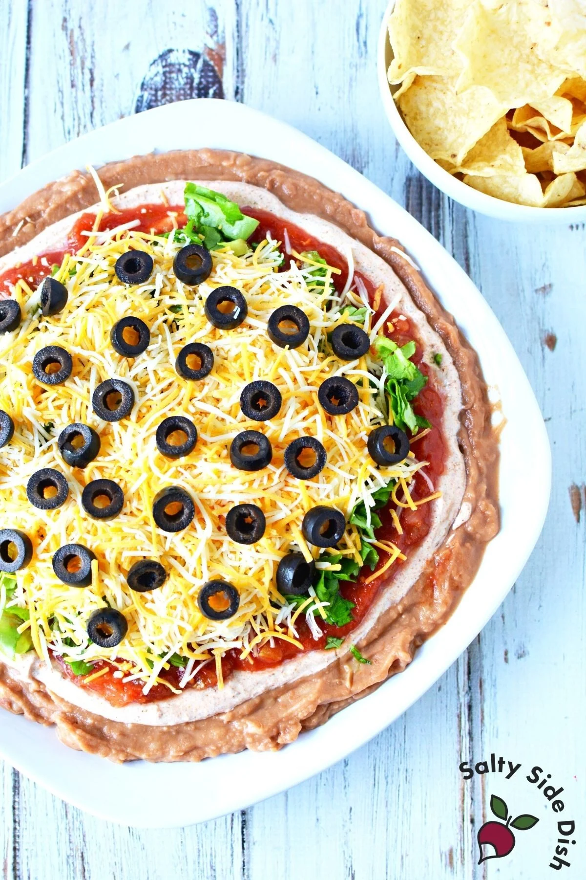 game day appetizer dip piled on a plate.