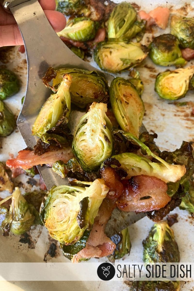 halved brussels sprouts with bacon on a spatula, already cooked