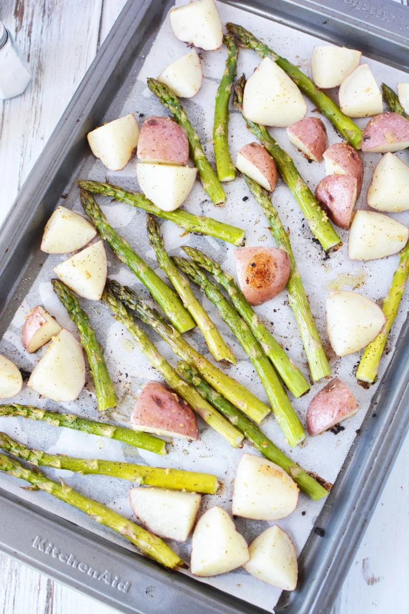 oven roasted asparagus and potatoes cooked still on a sheet pan