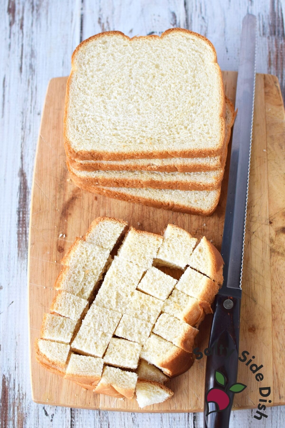 cutting bread into cubes.