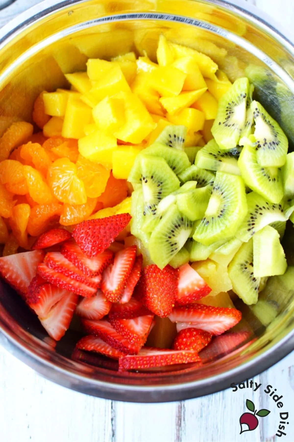 bowl full of cut and diced fruit.