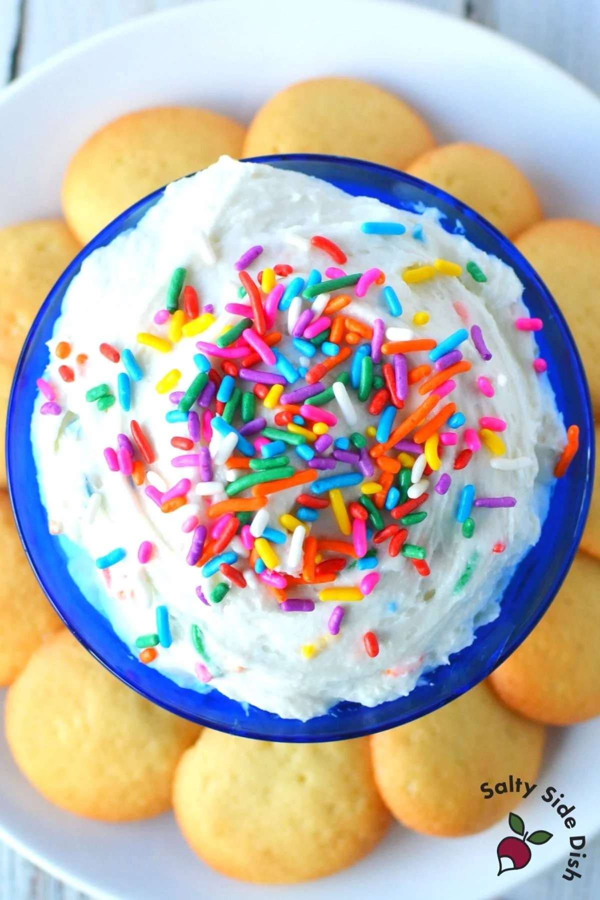 funfetti dip made with cake batter and filled with delicious sprinkles, surrounded by vanilla wafers to serve.