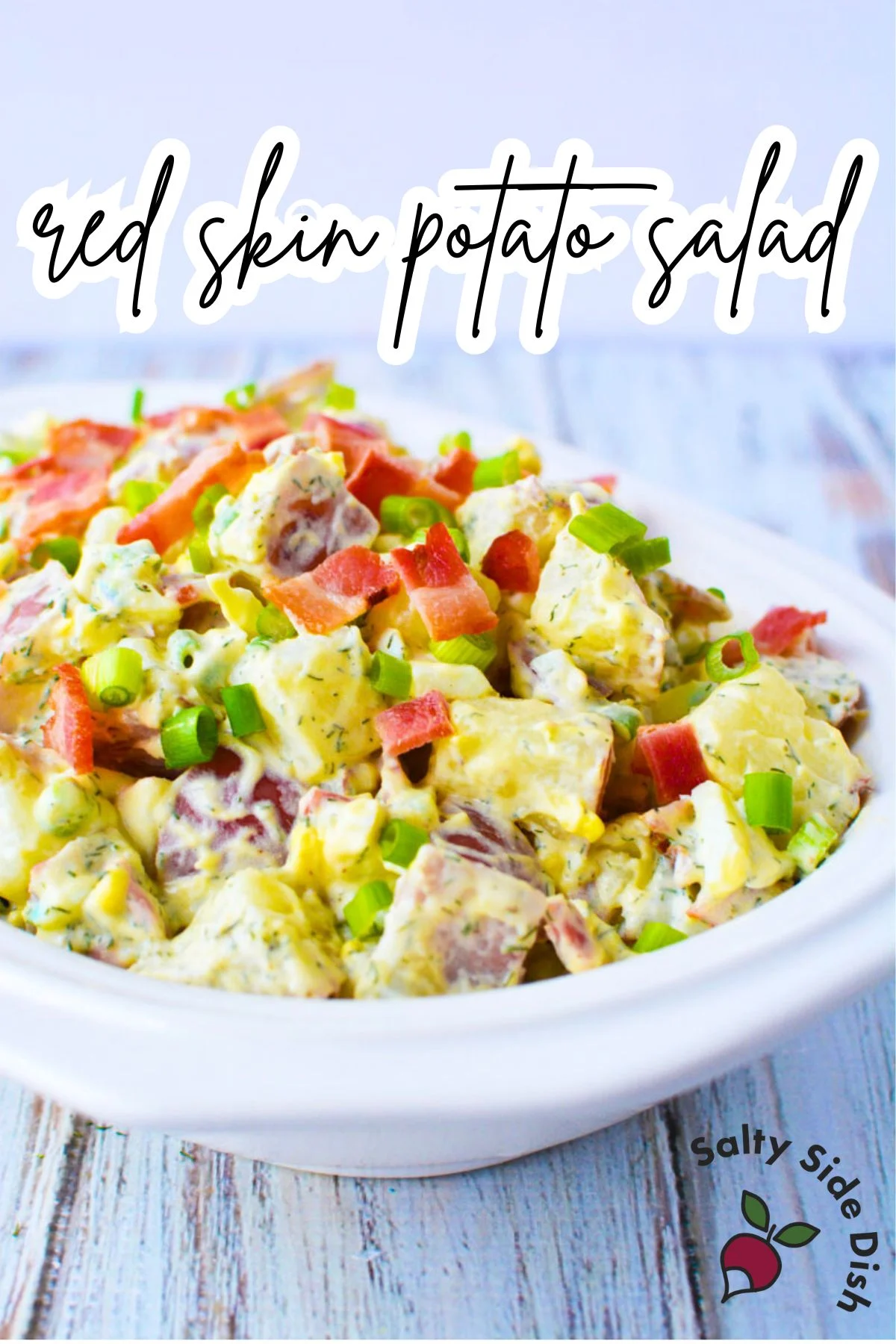 red skinned potato salad in a white bowl.