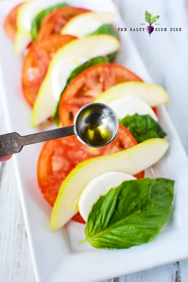 measuring olive for your caprese salad
