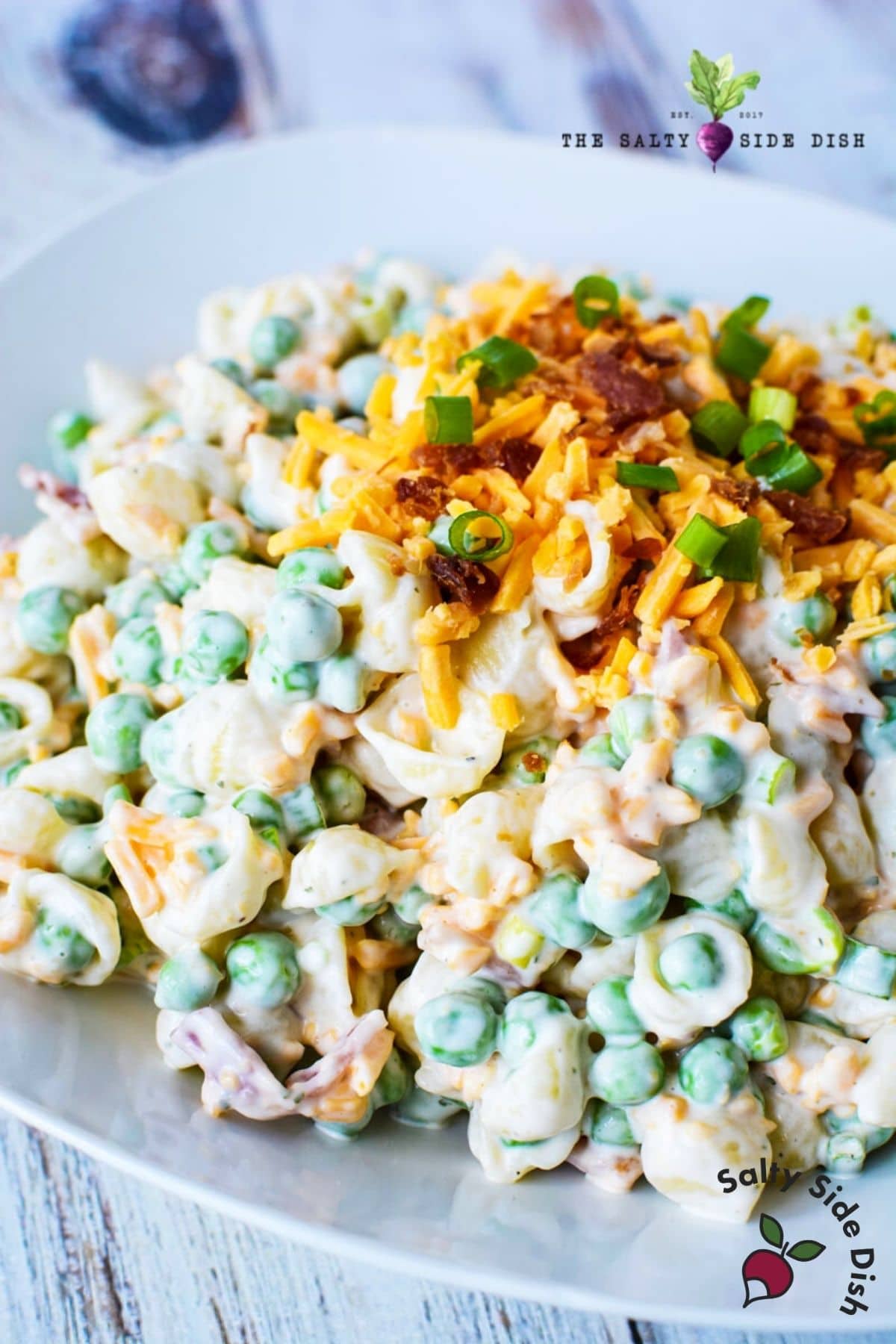 mini pasta shells with peas piled on a plate