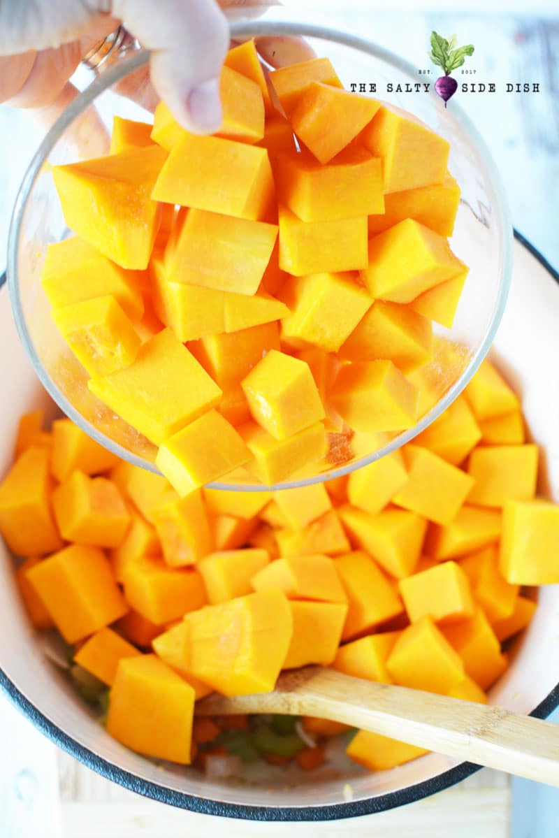 pour butternut squash into stock pot for boiling