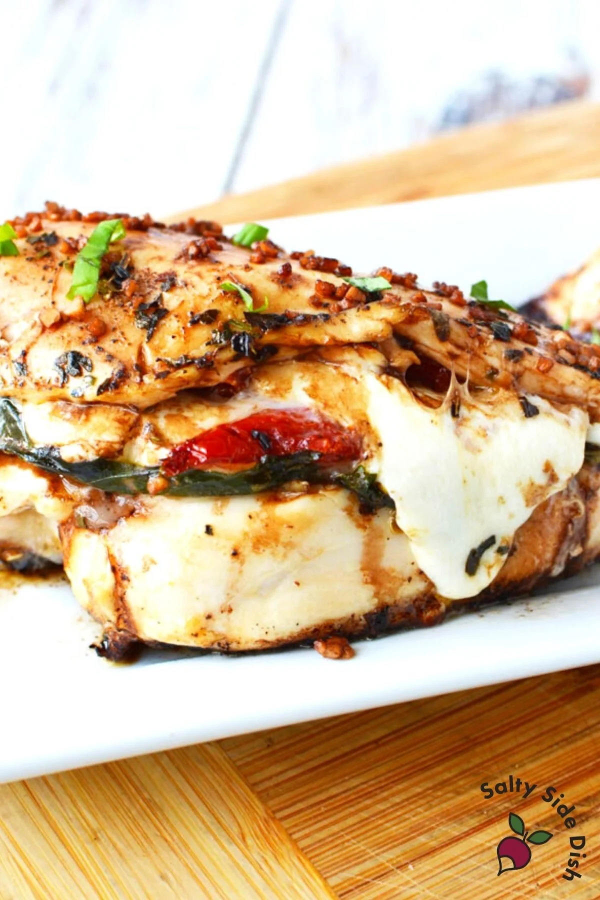 chicken breast with cheese and tomatoes falling out.