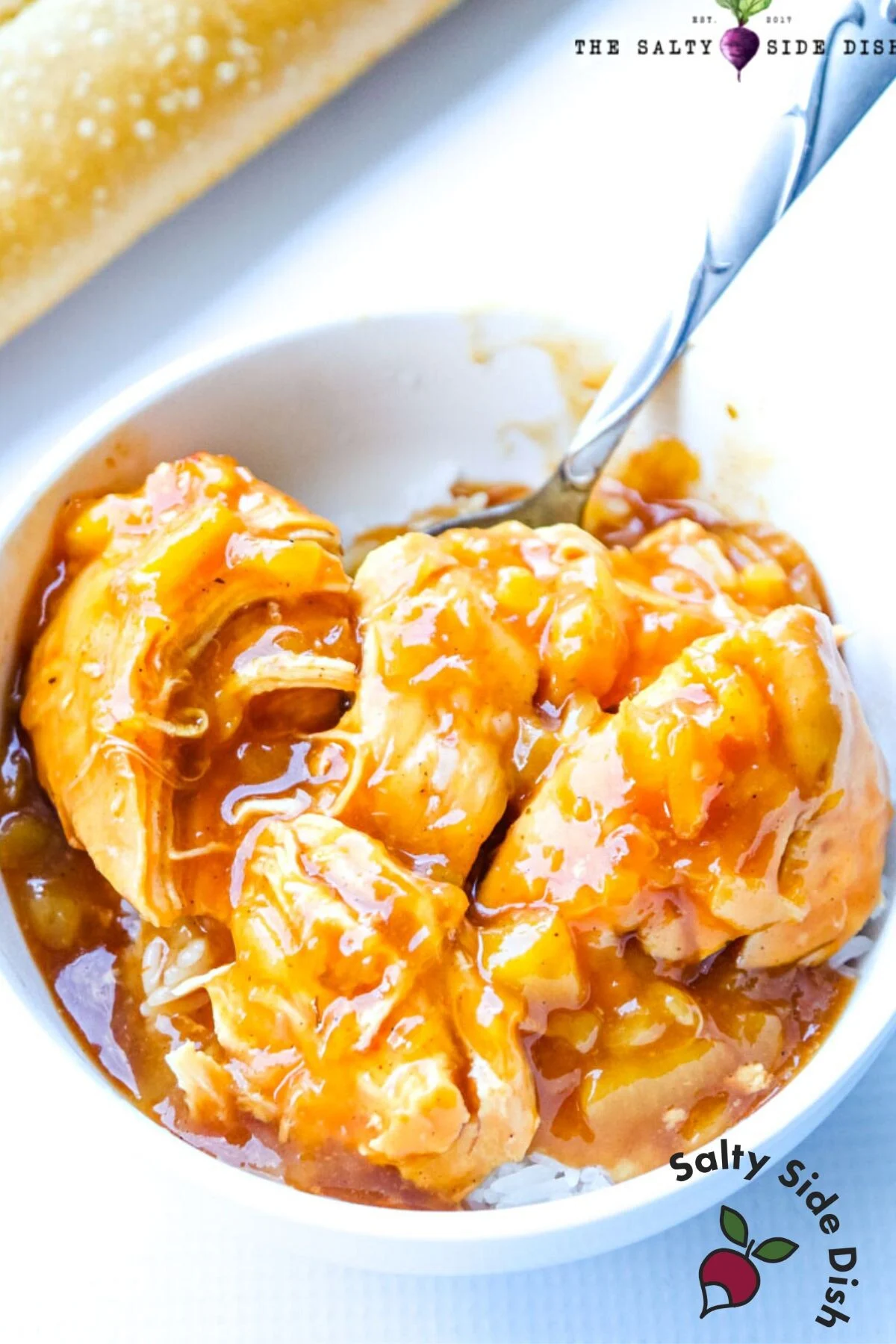 large bowl of Hawaiian chicken with a spoon.