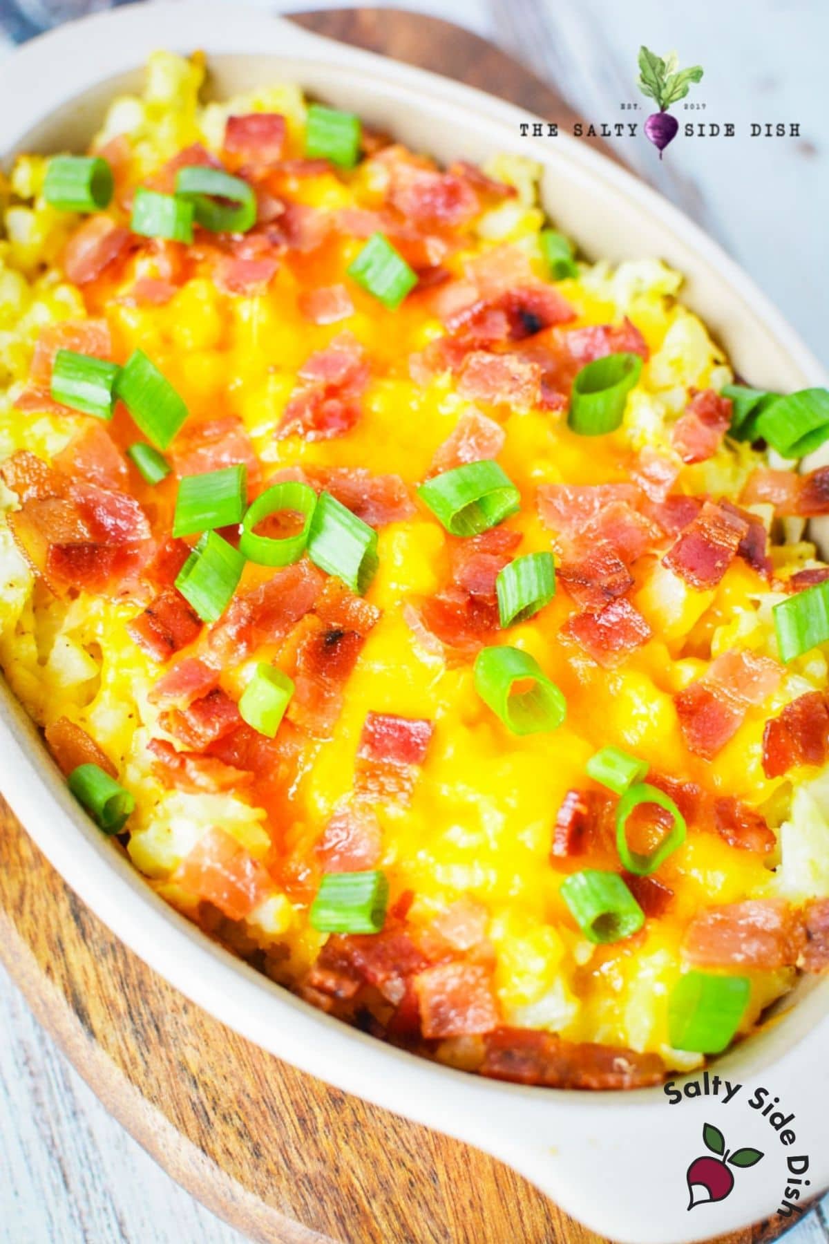 mashed cauliflower with cheese and bacon in a dish