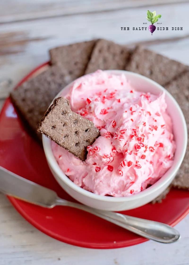 peppermint marshmallow fluff christmas dip on a tray with graham crackers
