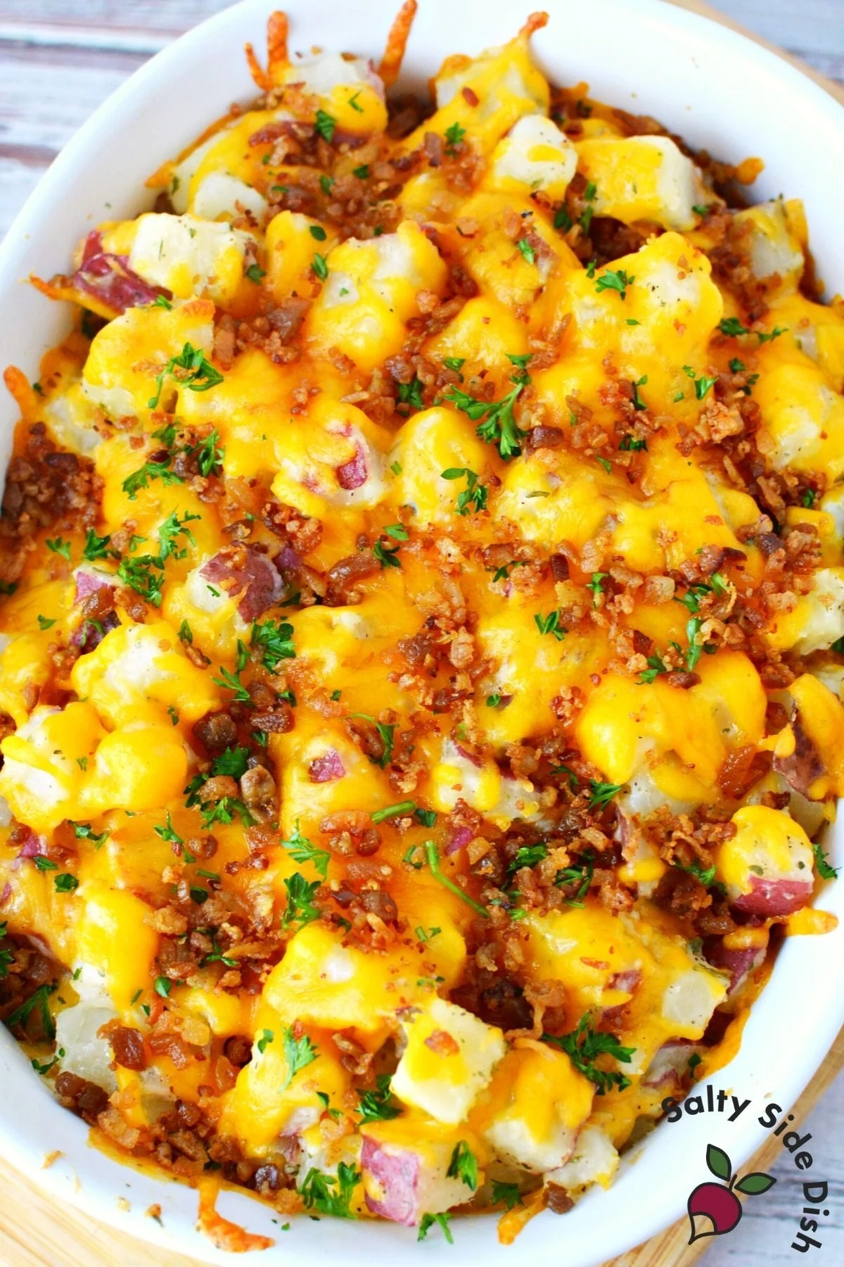 huge casserole baking dish of cheesy potato side dish.