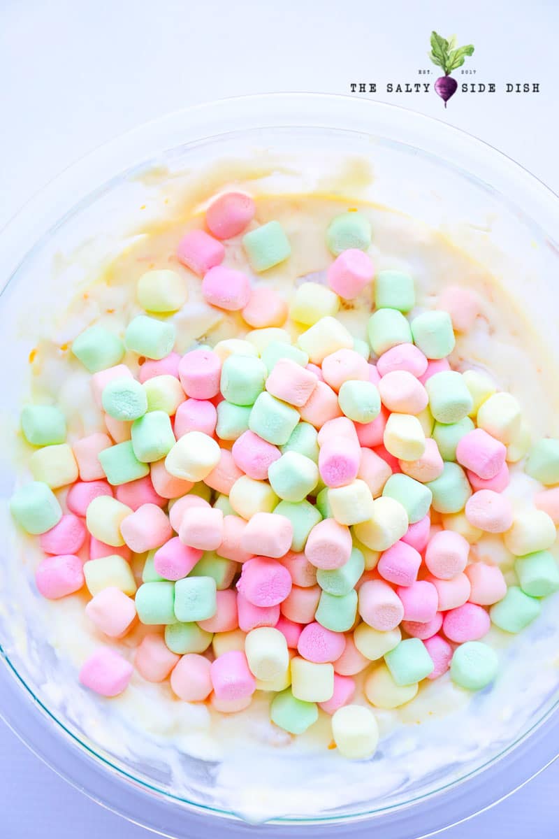 colored marshmallows in a clear bowl on top of the other ingredients.