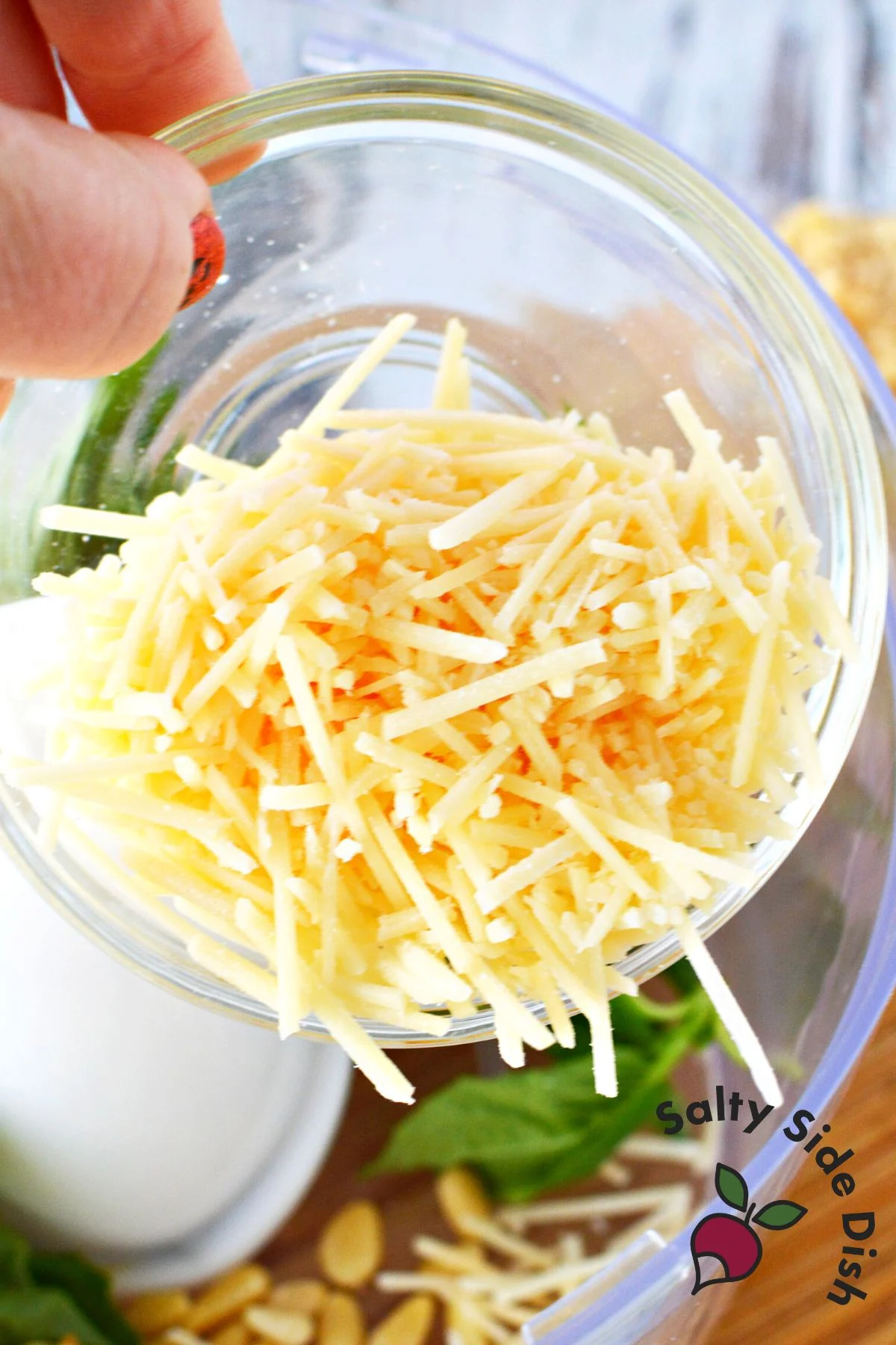 pouring out parmesan cheese.