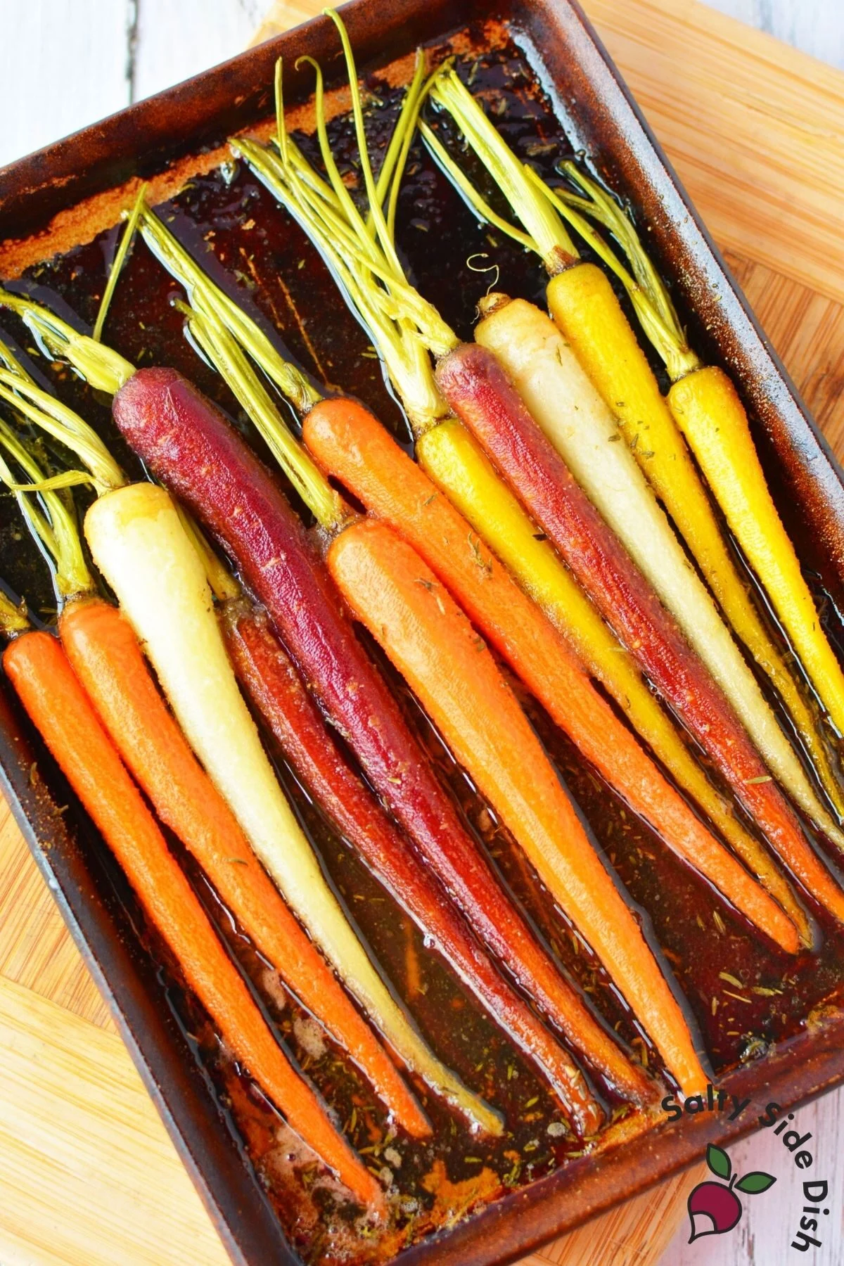colorful carrots on a baking sheet.