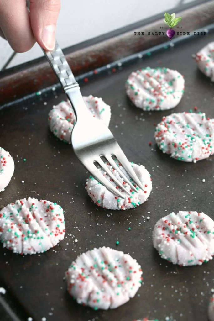 flatten mints with a fork on a baking pan