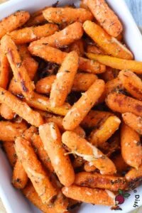 close up of parmesan roasted baby carrots showing crispy texture and melted cheese
