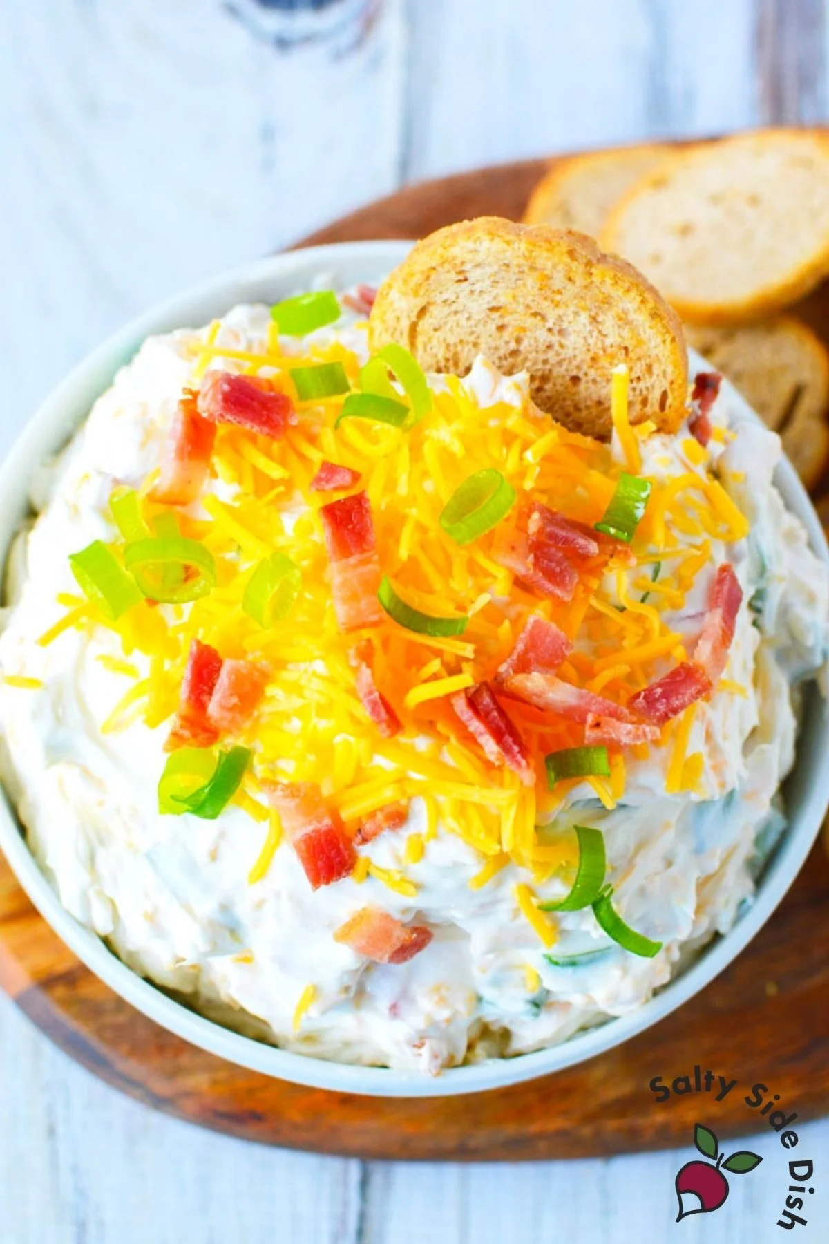 neiman marcus dip recipe in a large white bowl with melba toast.