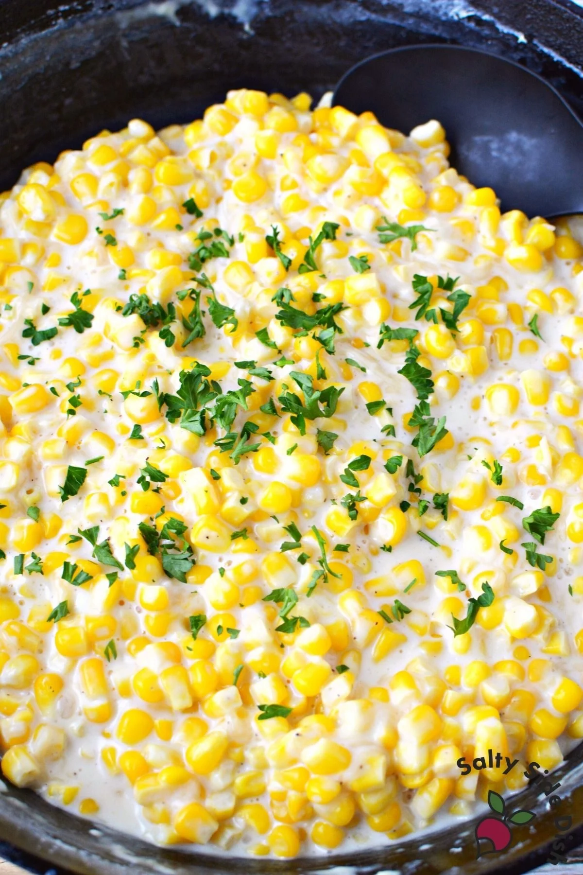 cast iron pan of old fashioned creamed corn.
