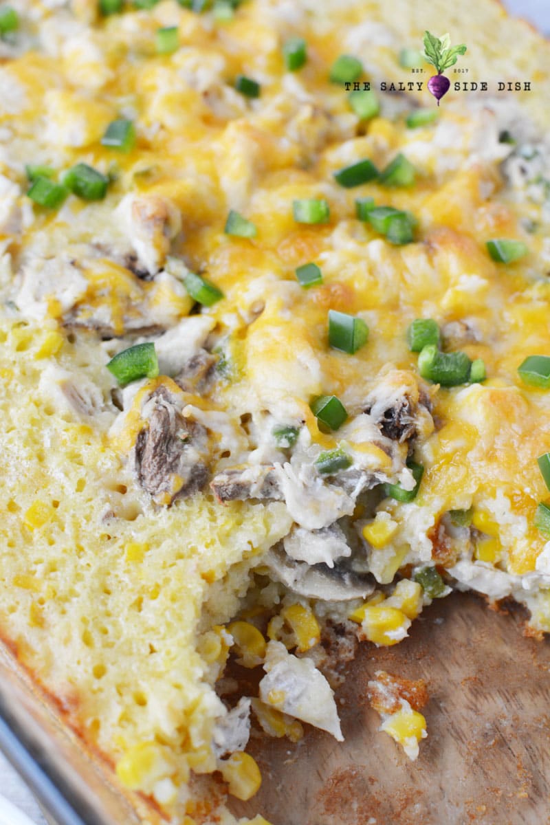 mexican corn casserole with a scoop out of it.