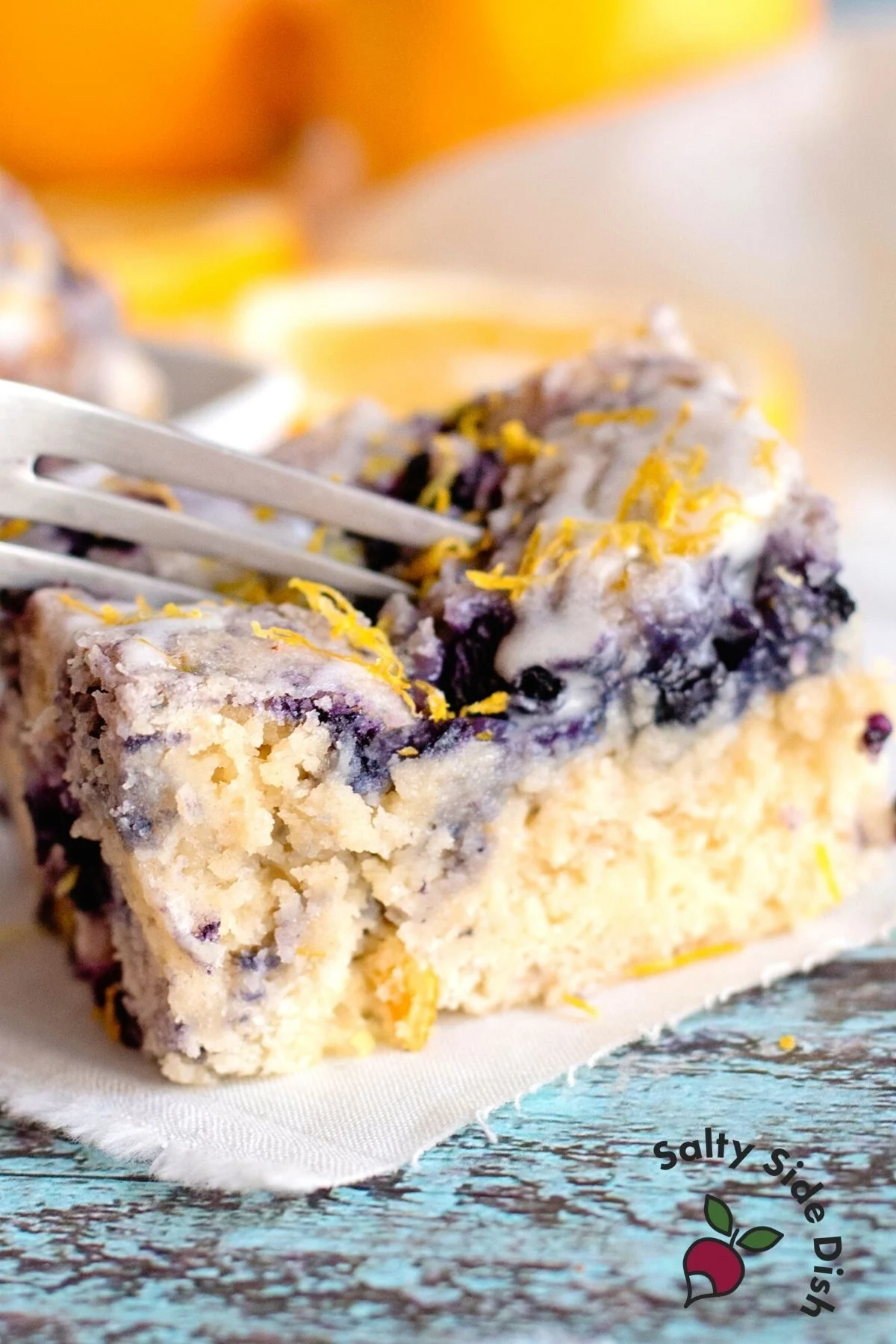 fork cutting into blueberry cake bars.