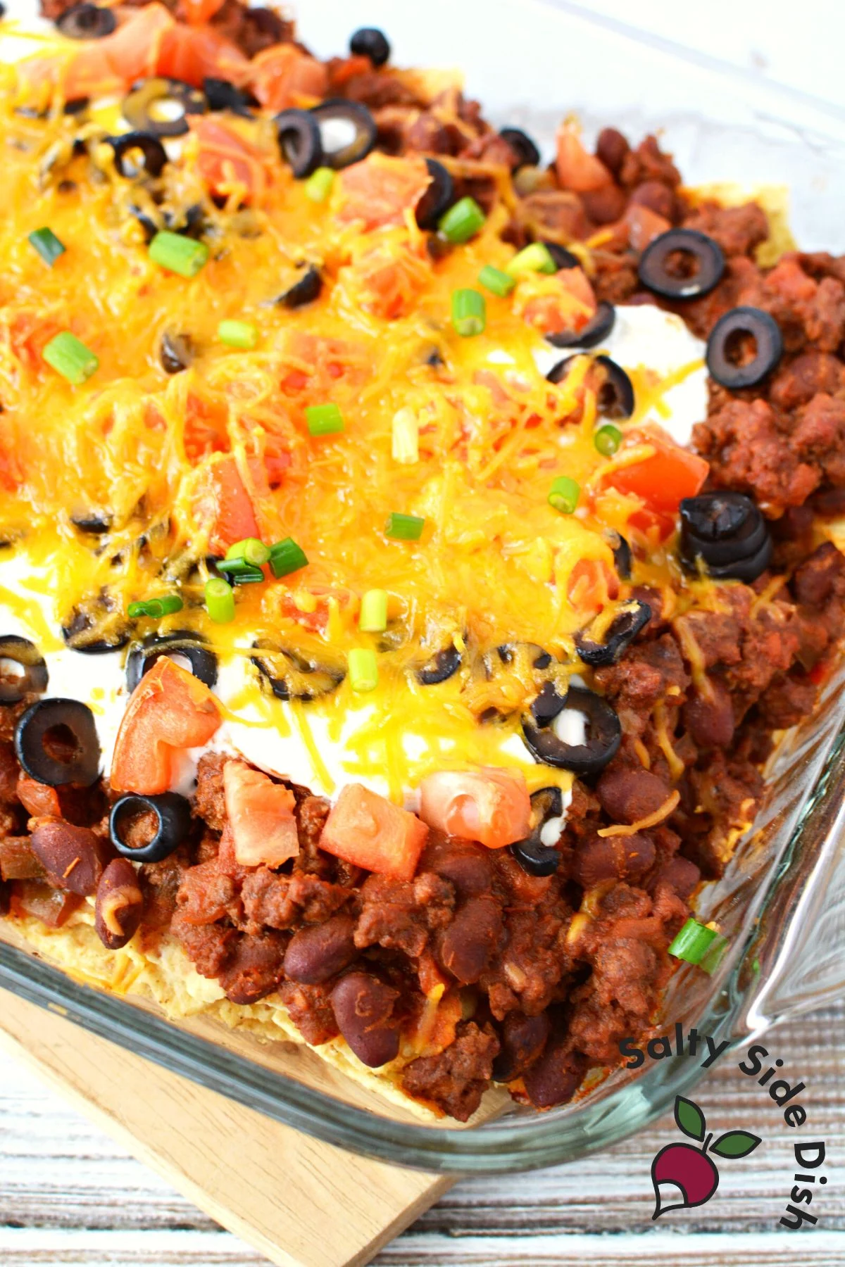 nacho casserole ready to eat in a baking casserole dish.