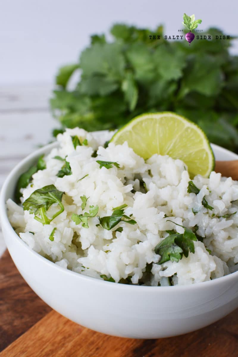 rice sitting in a white bowl with fresh lime