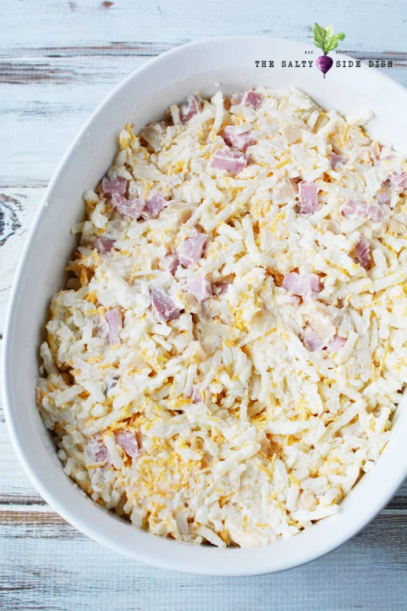 frozen hashbrowns with ham in a bowl ready to put in the oven
