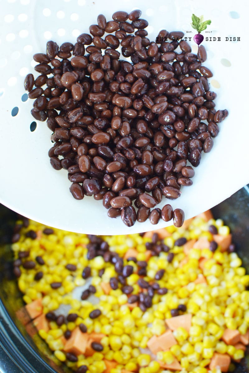 add black beans to corn and sweet potatoes in your crock pot or slow cooker