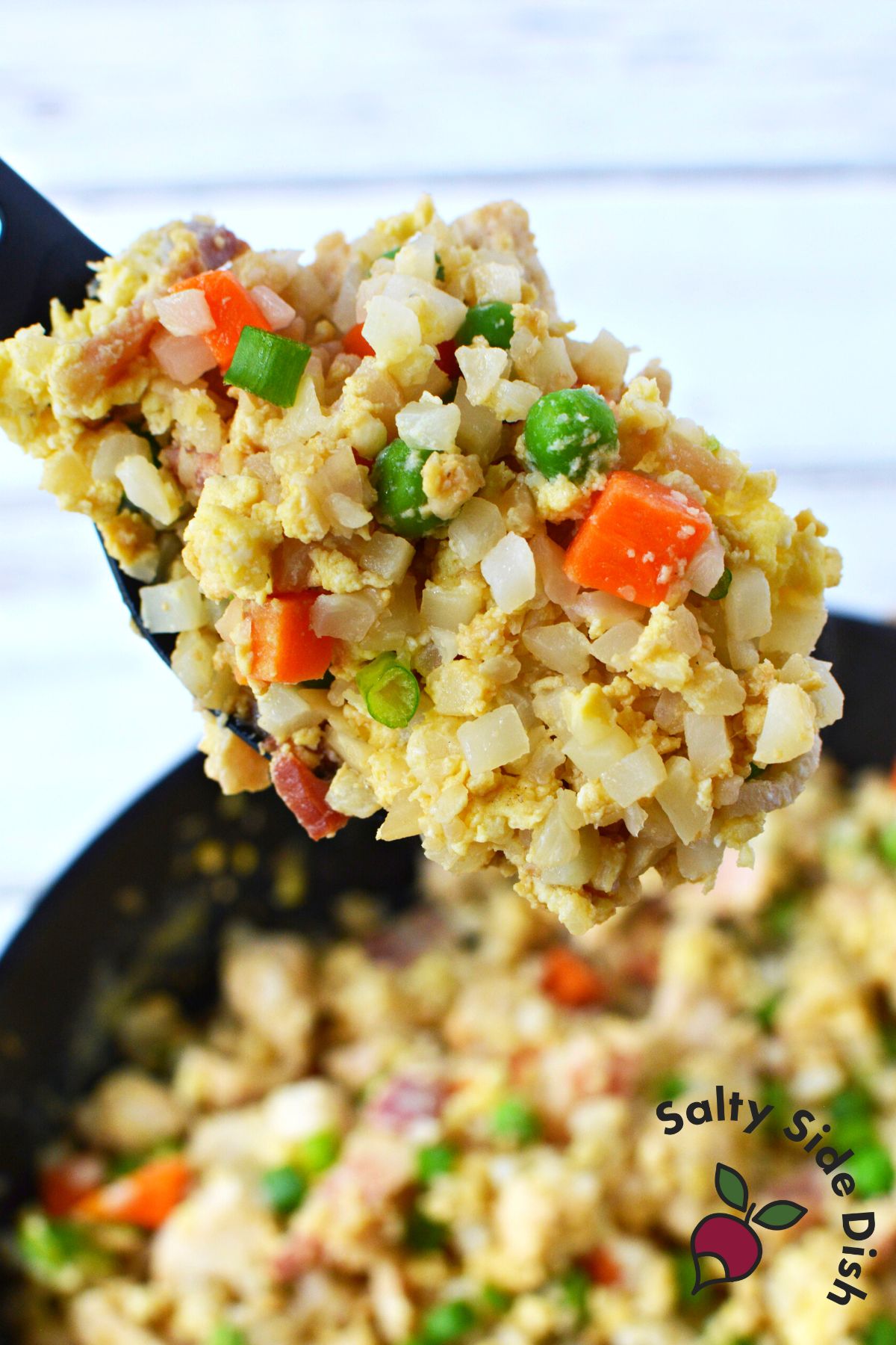 close up of spoon with cauliflower fried rice.