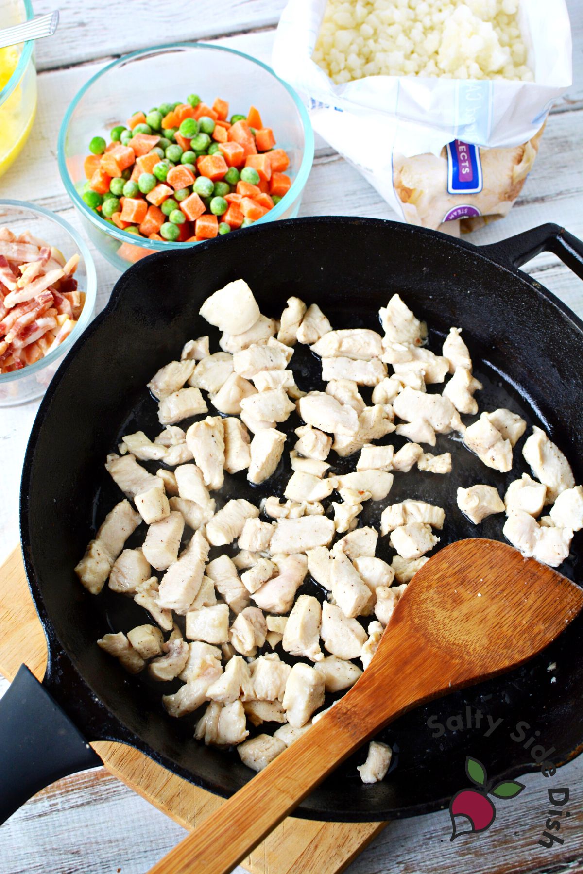 bite sized pieces of chicken cooked in a cast iron pan.