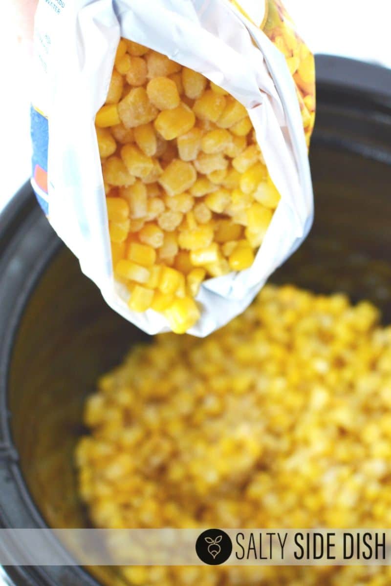 frozen corn being poured into a slow cooker