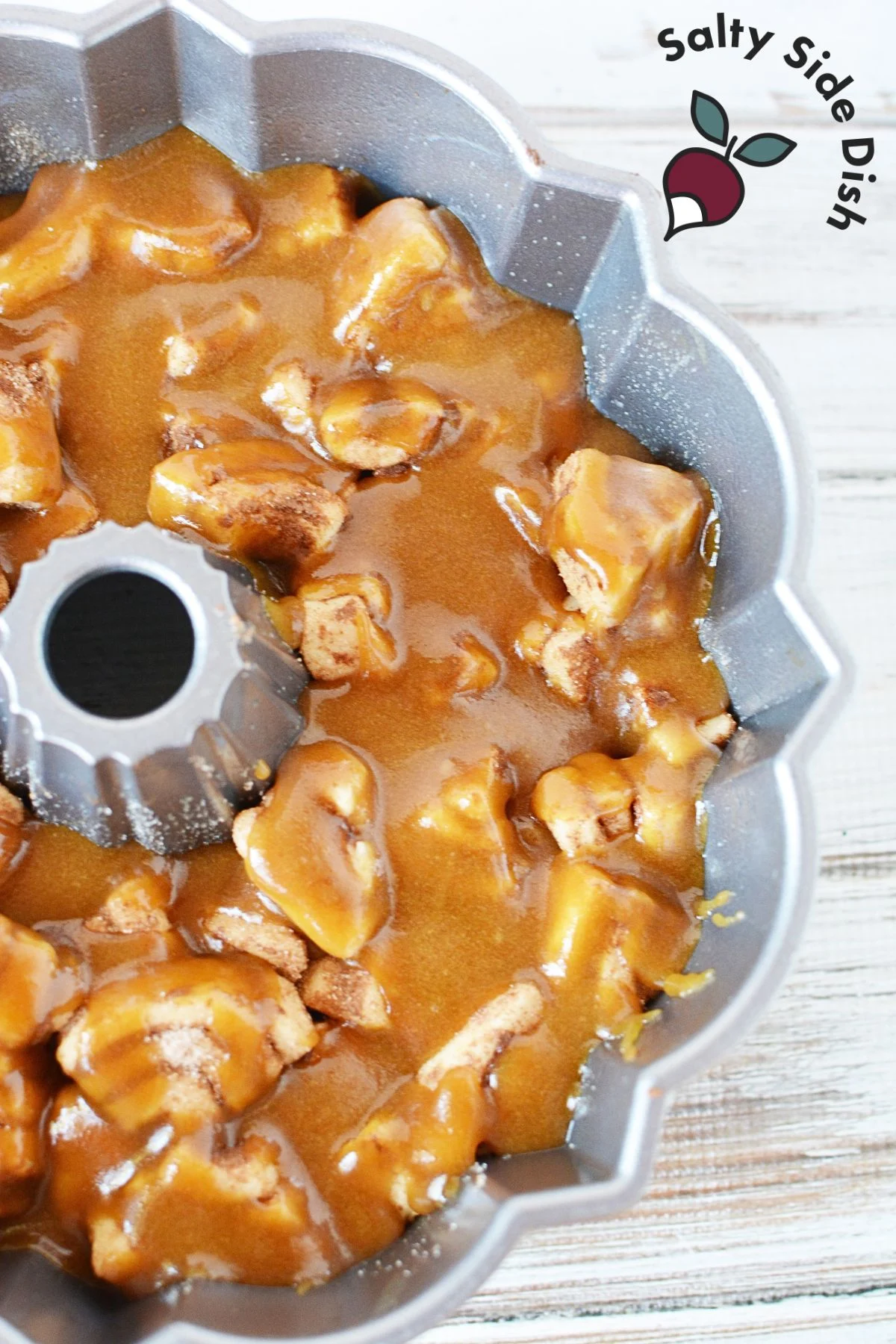 pour monkey bread sauce over pieces in bundt pan.